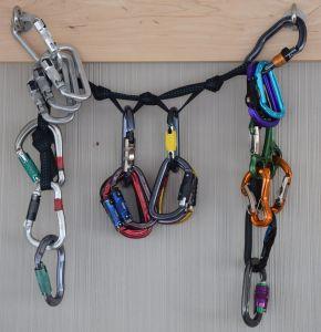 a couple dozen carabiners hang from webbing attached to two bolts